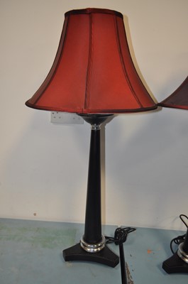 Lot 100 - A pair of modern ebonised table lamps, each...
