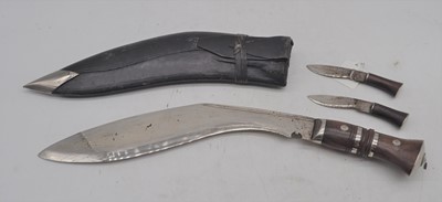 Lot 118 - A tourist market kukri, housed in a leather...
