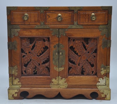 Lot 120 - A 20th century Chinese elm table cabinet, the...
