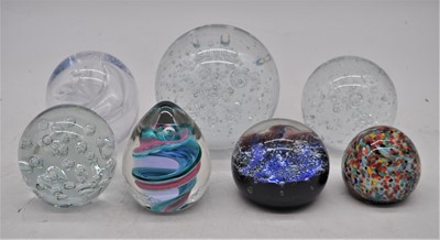 Lot 182 - A collection of 7 various glass paperweights,...