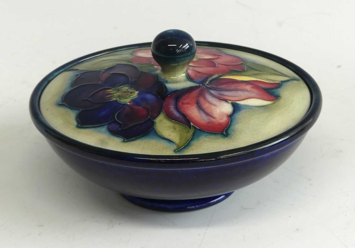 Lot 31 - A Moorcroft Clematis pattern pottery jar and...