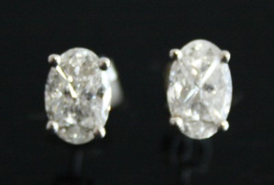 Lot 2218 - A pair of 18ct white gold diamond oval cluster...