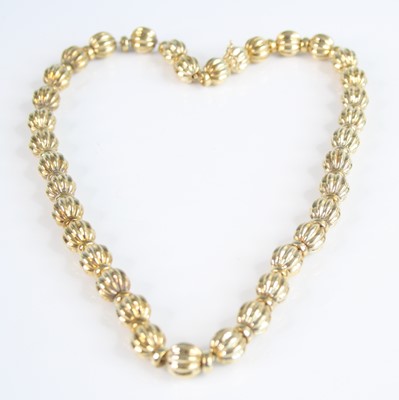 Lot 2227 - A 9ct yellow gold bead necklace by Champiesan,...