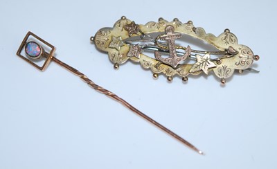 Lot 2537 - A rose metal stick pin featuring an oval opal...