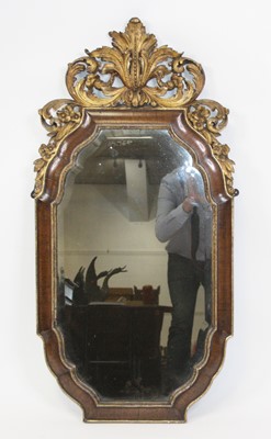 Lot 2648 - A George II walnut and parcel-gilt wall mirror,...