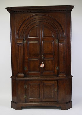 Lot 2655 - A George III oak corner cupboard in two...