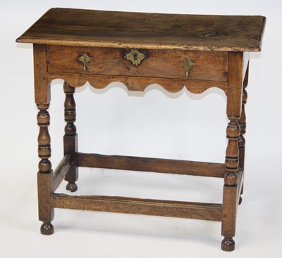 Lot 2664 - A George III walnut lowboy, having a one-piece...