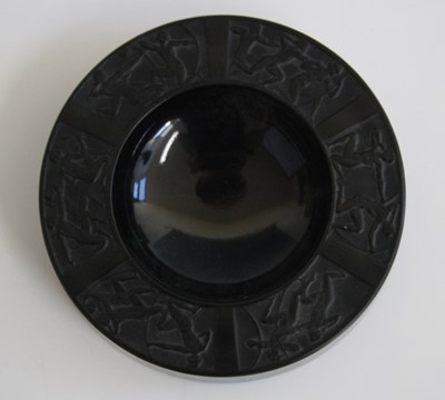 Lot 126 - A pressed black glass circular ashtray by...
