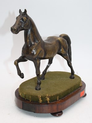 Lot 28 - A bronze model of a horse, mounted upon a...