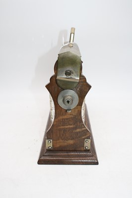 Lot 33 - An early 20th century oak three decanter...