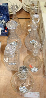 Lot 153 - A collection of seven cut glass decanters,...