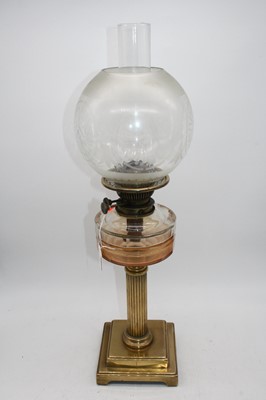 Lot 177 - A 19th century brass oil lamp, having acid...