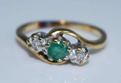 Lot 2562 - A yellow and white metal, emerald and diamond...