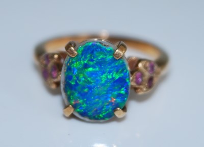 Lot 2564 - A yellow metal opal doublet dress ring, having...