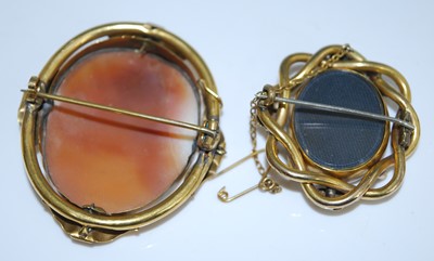 Lot 2547 - Two brooches, being a yellow metal oval carved...