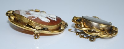 Lot 2547 - Two brooches, being a yellow metal oval carved...