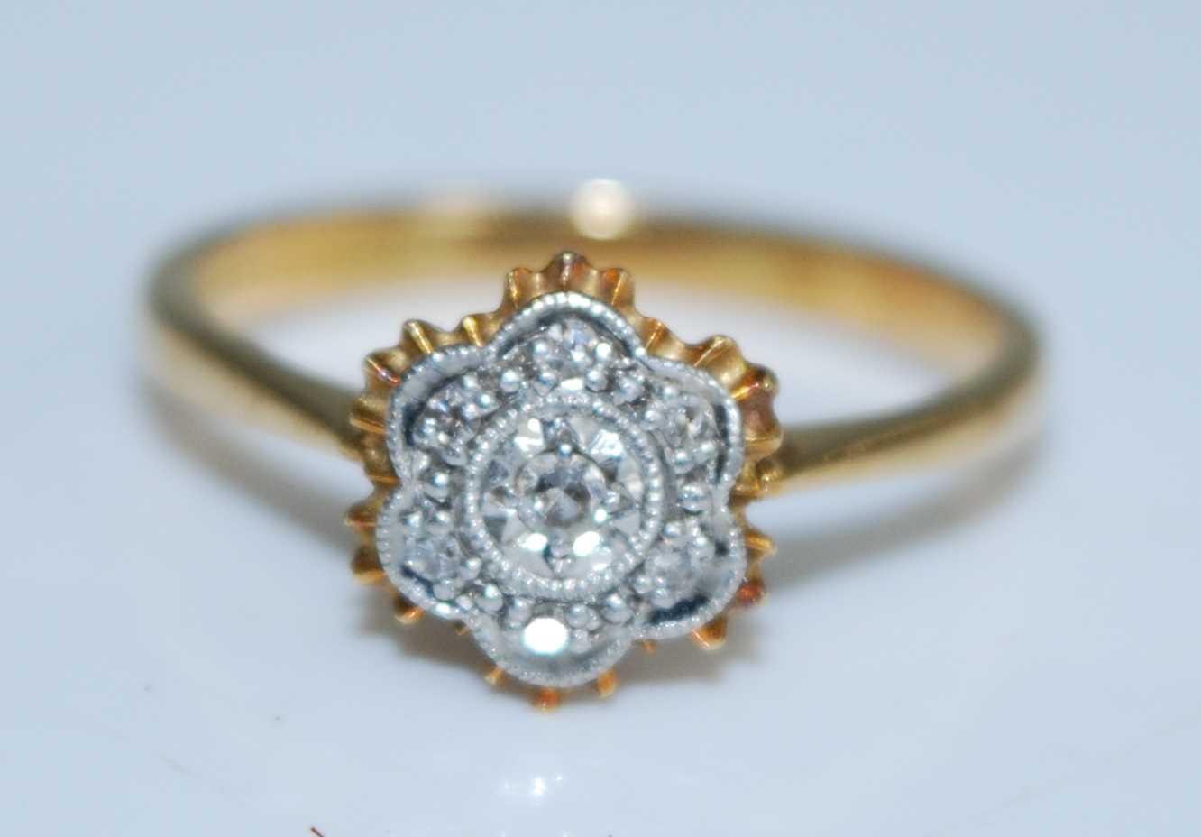 Lot 2560 - An 18ct yellow and white gold diamond circular...
