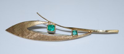 Lot 2582 - A yellow metal emerald abstract leaf brooch...