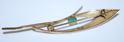 Lot 2582 - A yellow metal emerald abstract leaf brooch...