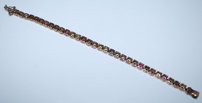 Lot 2595 - A yellow metal tourmaline line bracelet, the...