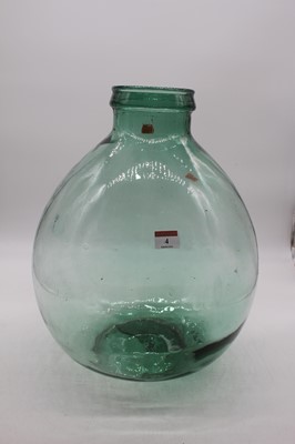 Lot 4 - A green tinted glass carboy height 39cm