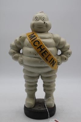 Lot 14 - A reproduction painted cast iron Michelin Man...