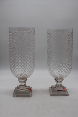 Lot 21 - A pair of modern cut glass storm lamps, height...