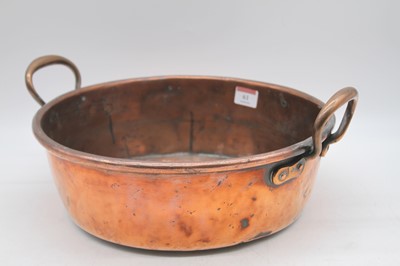 Lot 61 - An early 20th century copper twin handled jam...