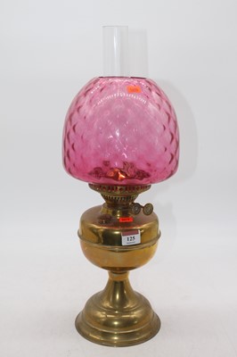 Lot 125 - An early 20th century brass pedestal oil lamp...
