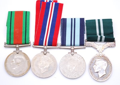 Lot 236 - A group of four WW II medals, to include...