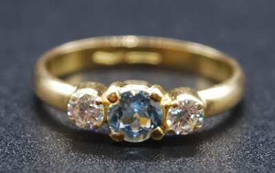 Lot 2605 - A yellow metal, aquamarine and diamond three...