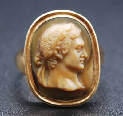 Lot 2615 - A yellow metal carved Lava Stone cameo ring...