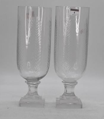 Lot 5 - A pair of cut glass storm lamps, each upon a...