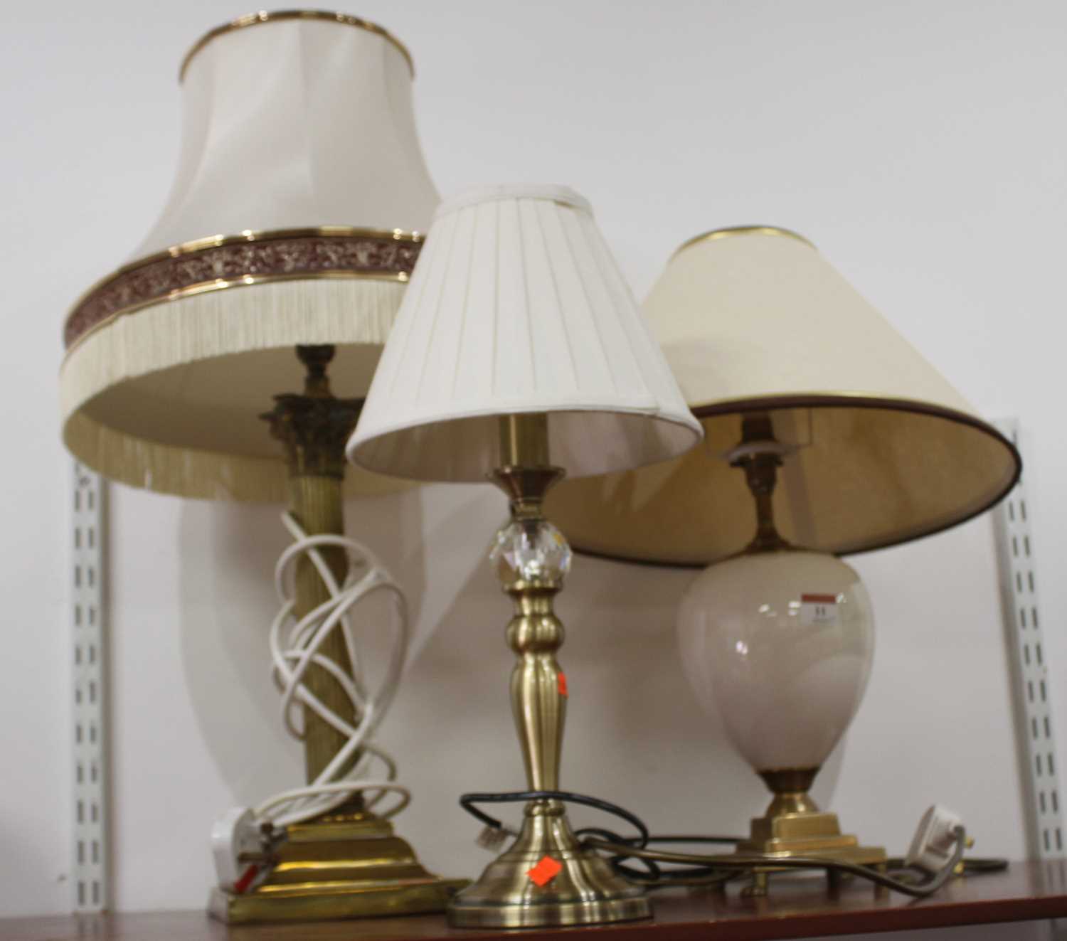 Lot 11 - A 20th century brass table lamp in the form of...