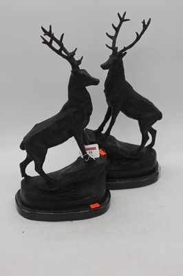 Lot 55 - A pair of bronze stags, each shown standing...