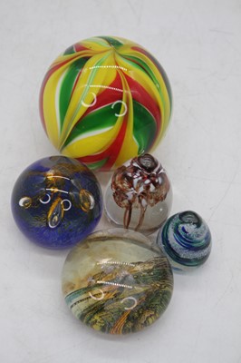 Lot 79 - A collection of glass paperweights, to include...