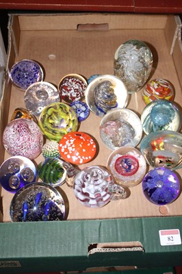 Lot 82 - A collection of glass paperweights, to include...
