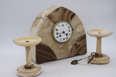 Lot 118 - An Art Deco polished hardstone clock garniture,...