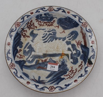 Lot 204 - A Chinese stoneware dish, relief decorated...