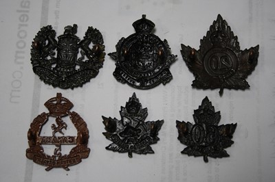Lot 64 - A collection of Canadian cap badges and...