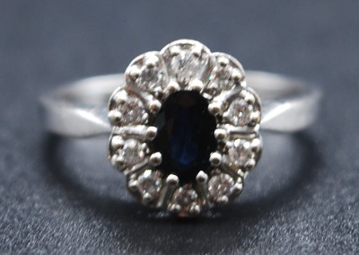 Lot 2617 - An 18ct white gold, sapphire and diamond oval...