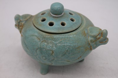 Lot 212 - A Chinese blue glazed tripod censor, flanked...