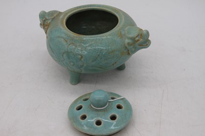 Lot 212 - A Chinese blue glazed tripod censor, flanked...