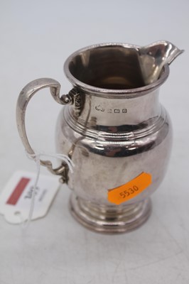 Lot 309 - A George V silver milk jug, Birmingham 1931,...