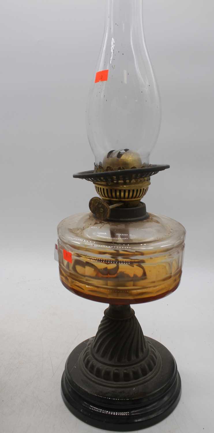 Lot 73 - A Victorian oil lamp, having amber glass font,...