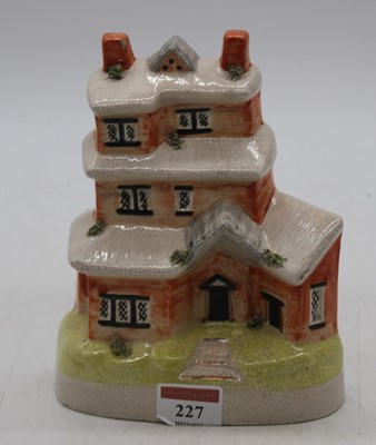 Lot 227 - A Staffordshire pottery model of a cottage,...