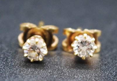 Lot 2712 - A pair of yellow metal diamond single stone...