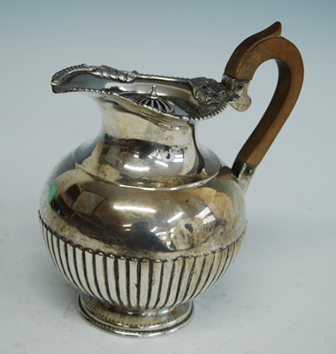 Lot 2157 - A late Victorian silver hot water jug, of half-...