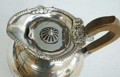 Lot 2157 - A late Victorian silver hot water jug, of half-...