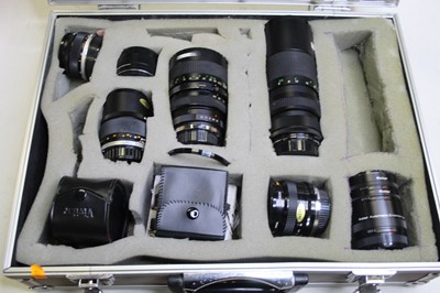 Lot 349 - A flight case containing eight camera lenses,...